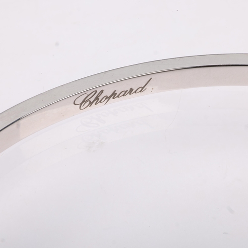 1141 - CHOPARD - an 18ct white gold diamond 'Happy Diamonds' hinged bangle, circa 2004, set with 0.05ct flo... 