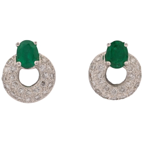 1161 - A pair of 18ct white gold emerald and diamond hoop earrings, maker HM Ltd, London 2004, claw set wit... 