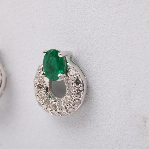 1161 - A pair of 18ct white gold emerald and diamond hoop earrings, maker HM Ltd, London 2004, claw set wit... 