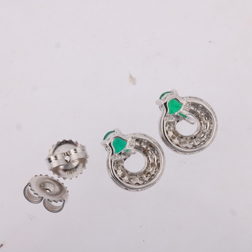 1161 - A pair of 18ct white gold emerald and diamond hoop earrings, maker HM Ltd, London 2004, claw set wit... 