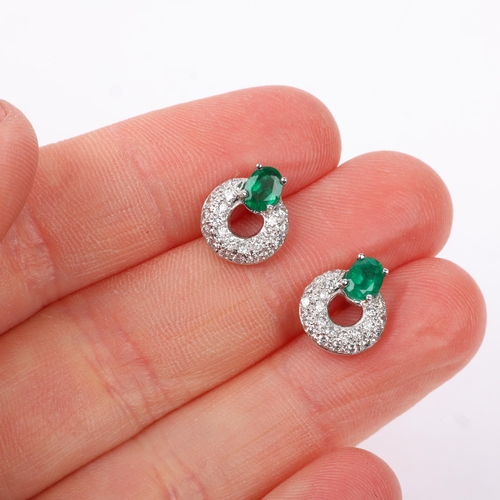 1161 - A pair of 18ct white gold emerald and diamond hoop earrings, maker HM Ltd, London 2004, claw set wit... 