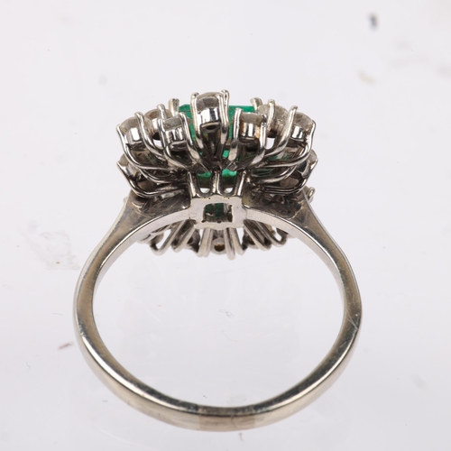 1162 - A late 20th century 18ct white gold emerald and diamond cluster cocktail ring, centrally claw set wi... 