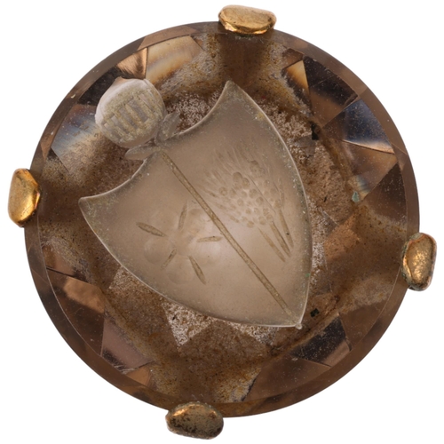 1166 - A late 20th century 9ct gold smoky quartz armorial seal ring, the round smoky quartz intaglio carved... 