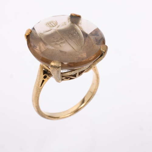 1166 - A late 20th century 9ct gold smoky quartz armorial seal ring, the round smoky quartz intaglio carved... 