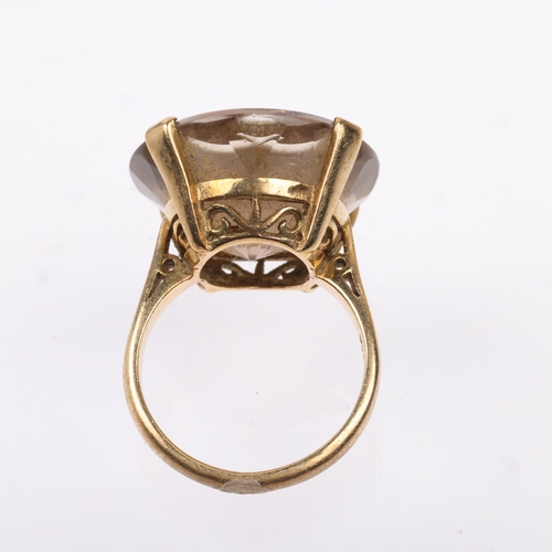 1166 - A late 20th century 9ct gold smoky quartz armorial seal ring, the round smoky quartz intaglio carved... 