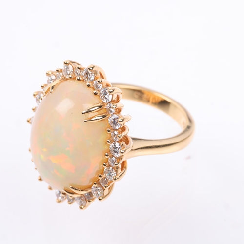 1171 - An impressive 18ct gold Ethiopian opal and diamond oval cluster ring, centrally double claw set with... 