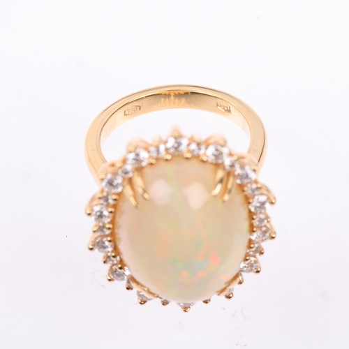 1171 - An impressive 18ct gold Ethiopian opal and diamond oval cluster ring, centrally double claw set with... 