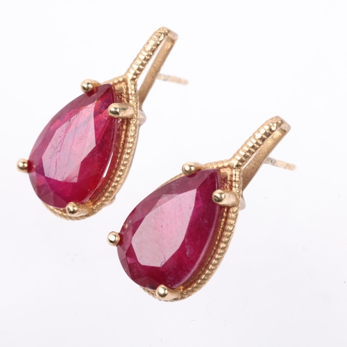 1227 - A pair of 9ct gold ruby earrings, each set with 5ct pear-cut ruby, with stud fittings, 21.9mm, 5.2g