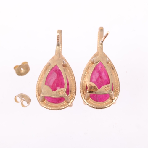 1227 - A pair of 9ct gold ruby earrings, each set with 5ct pear-cut ruby, with stud fittings, 21.9mm, 5.2g