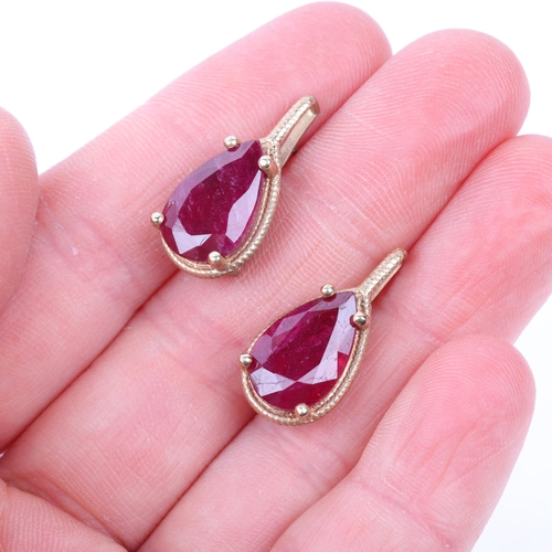 1227 - A pair of 9ct gold ruby earrings, each set with 5ct pear-cut ruby, with stud fittings, 21.9mm, 5.2g