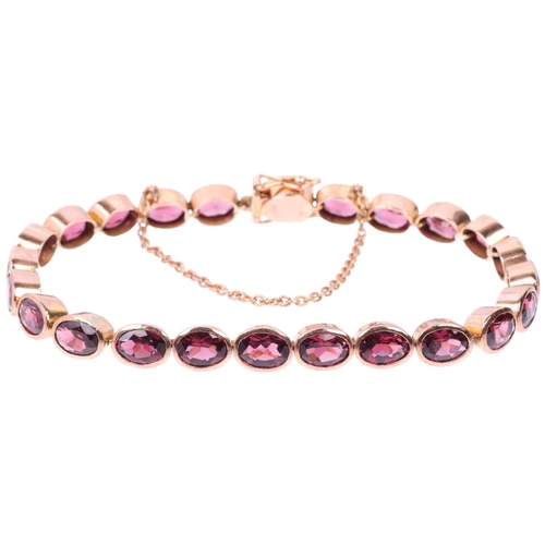 1231 - A modern 9ct rose gold garnet tennis line bracelet, maker SA, London 2009, rub-over set with oval mi... 