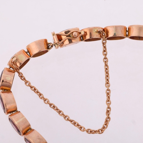 1231 - A modern 9ct rose gold garnet tennis line bracelet, maker SA, London 2009, rub-over set with oval mi... 