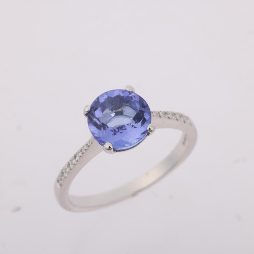 1234 - An 18ct white gold tanzanite and diamond dress ring, claw set with round-cut tanzanite and modern ro... 