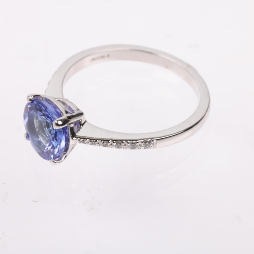 1234 - An 18ct white gold tanzanite and diamond dress ring, claw set with round-cut tanzanite and modern ro... 