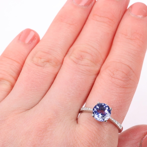 1234 - An 18ct white gold tanzanite and diamond dress ring, claw set with round-cut tanzanite and modern ro... 