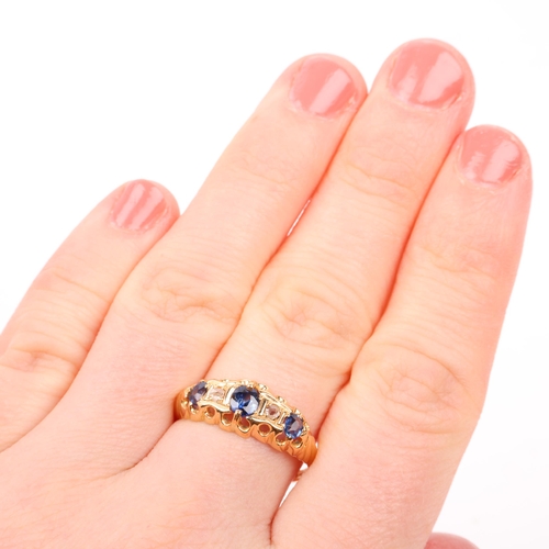 1251 - An early 20th century 18ct gold graduated five stone sapphire and diamond half hoop ring, maker HG&S... 