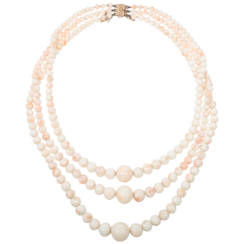 1252 - A Vintage triple-strand graduated 'Angel Skin' coral bead necklace, with 9ct gold clasp, coral beads... 