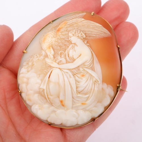 1253 - A large Victorian shell cameo brooch, relief carved depicting Hebe feeding eagle Zeus, in unmarked g... 