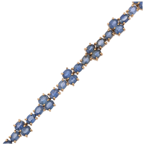 1273 - A modern 9ct gold sapphire tennis line bracelet, Birmingham 2005, set with oval mixed-cut sapphires,... 