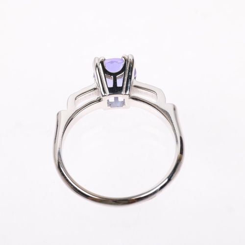 1277 - A modern tanzanite and diamond dress ring, set with round-cut tanzanite and modern round brilliant-c... 