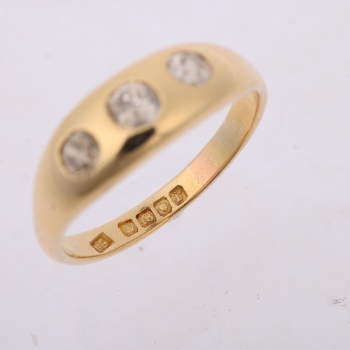 1281 - An early 20th century 18ct gold three stone diamond gypsy ring, maker DS, London 1912, rub-over set ... 