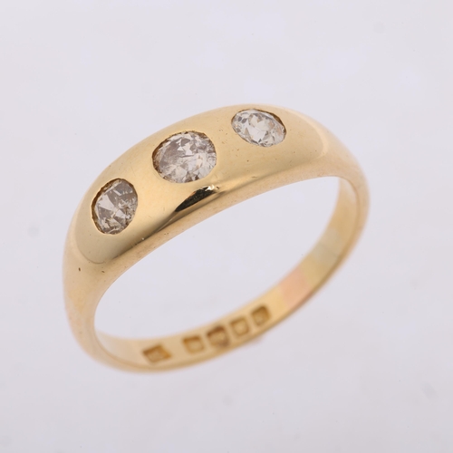 1281 - An early 20th century 18ct gold three stone diamond gypsy ring, maker DS, London 1912, rub-over set ... 