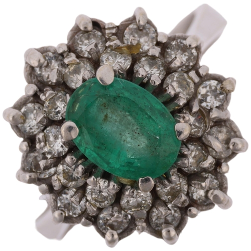 1290 - A Continental 18ct white gold emerald and diamond flowerhead cluster ring, claw set with oval mixed-... 