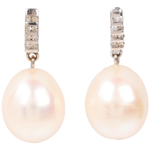 1297 - A pair of 9ct white gold whole pearl and diamond drop earrings, with stud fittings, 25.5mm, 6.5g