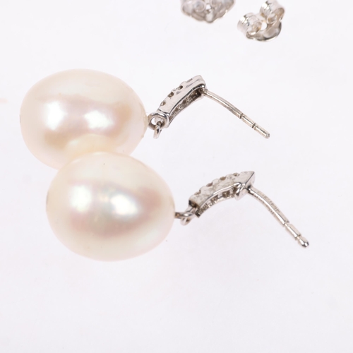 1297 - A pair of 9ct white gold whole pearl and diamond drop earrings, with stud fittings, 25.5mm, 6.5g