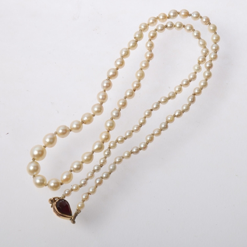 1298 - A Vintage single-strand graduated pearl bead necklace, unmarked gold garnet clasp, pearls measure 3.... 