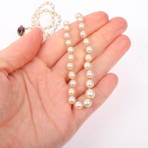 1298 - A Vintage single-strand graduated pearl bead necklace, unmarked gold garnet clasp, pearls measure 3.... 