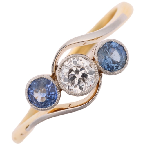 1309 - An early 20th century 18ct gold three stone sapphire and diamond crossover ring, platinum-topped set... 