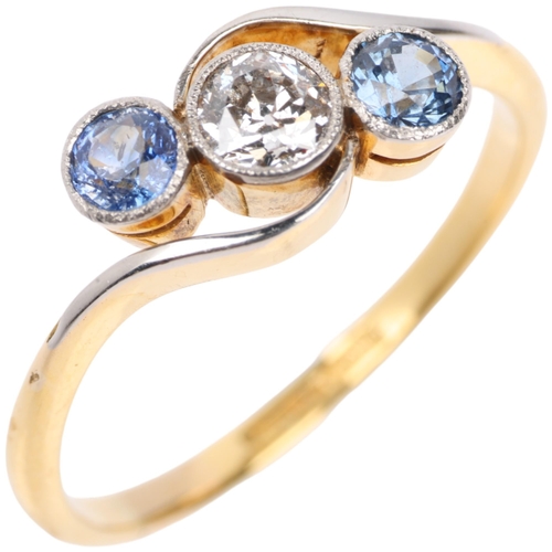 1309 - An early 20th century 18ct gold three stone sapphire and diamond crossover ring, platinum-topped set... 