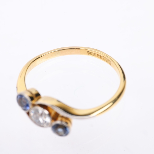 1309 - An early 20th century 18ct gold three stone sapphire and diamond crossover ring, platinum-topped set... 