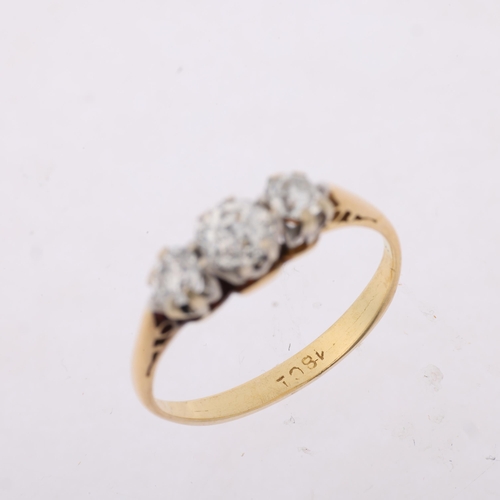 1314 - An early 20th century 18ct gold three stone diamond ring, claw set with old European-cut diamonds, t... 