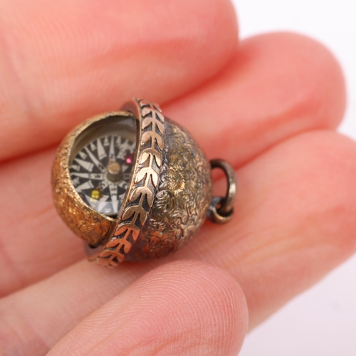 1356 - An Antique miniature gimballed compass fob, allover foliate engraved decoration, apparently unmarked... 