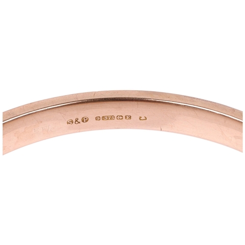 1362 - An early 20th century 9ct rose gold plain slave bangle, maker S&P, Birmingham 1929, allover engine t... 