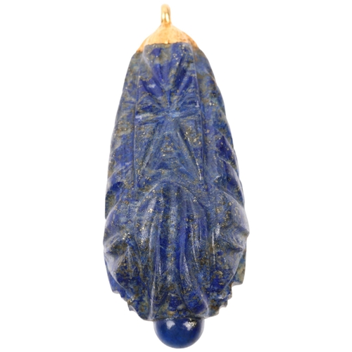 1371 - A large Ethnic carved lapis lazuli idol head teardrop pendant, with unmarked yellow metal mount, 69.... 