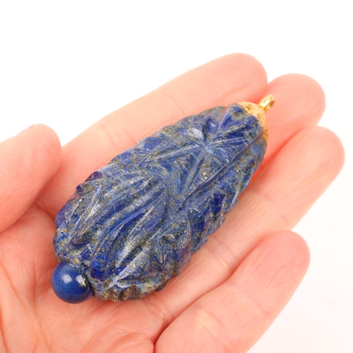 1371 - A large Ethnic carved lapis lazuli idol head teardrop pendant, with unmarked yellow metal mount, 69.... 