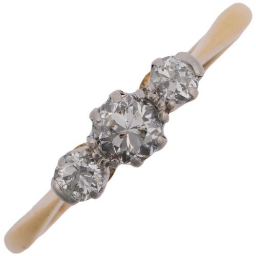 1373 - A mid-20th century 18ct gold three stone diamond ring, platinum-topped, set with round-cut diamonds,... 