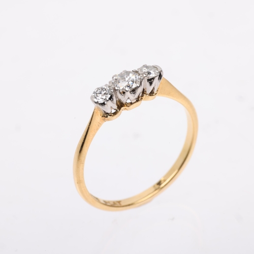 1373 - A mid-20th century 18ct gold three stone diamond ring, platinum-topped, set with round-cut diamonds,... 