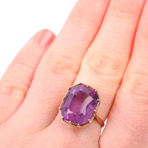 1403 - A mid-20th century amethyst dress ring, collet set with emerald step-cut amethyst, apparently unmark... 