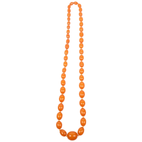 1411 - A long single-strand graduated amber bead necklace, beads ranging from 12.0 - 12.6mm, necklace 74cm,... 