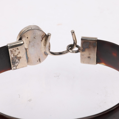 1434 - An early 20th century tortoiseshell and amber torque bangle, band width 12.8mm, internal circumferen... 