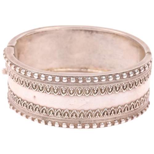 1438 - A Victorian sterling silver hinged bangle, with relief heart decoration, band width 24.8mm, internal... 