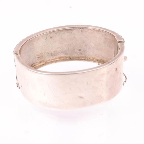 1438 - A Victorian sterling silver hinged bangle, with relief heart decoration, band width 24.8mm, internal... 