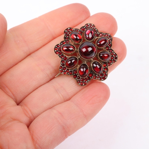 1439 - A Victorian Bohemian garnet flowerhead cluster brooch, set with round and oval cabochon garnet flowe... 