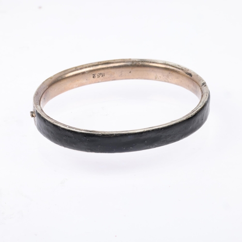 1445 - A Victorian French silver and black enamel 'God bless you' hinged mourning bangle, band width 9.2mm,... 