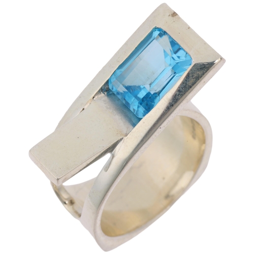 1453 - A modern sterling silver blue topaz crossover ring, London 2023, band width 11.4mm, size P, 13g