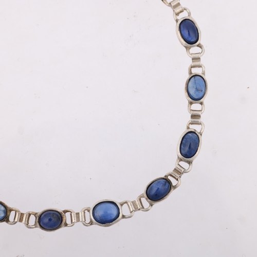 1454 - A modern sterling silver sapphire tennis line bracelet, set with oval cabochon sapphires, 20.5cm, 8.... 